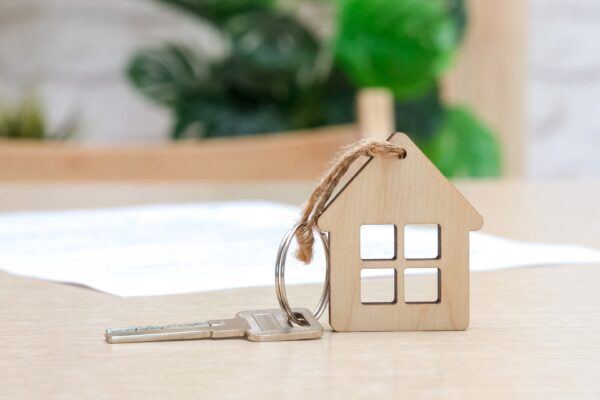 small wooden house with a key attached to it