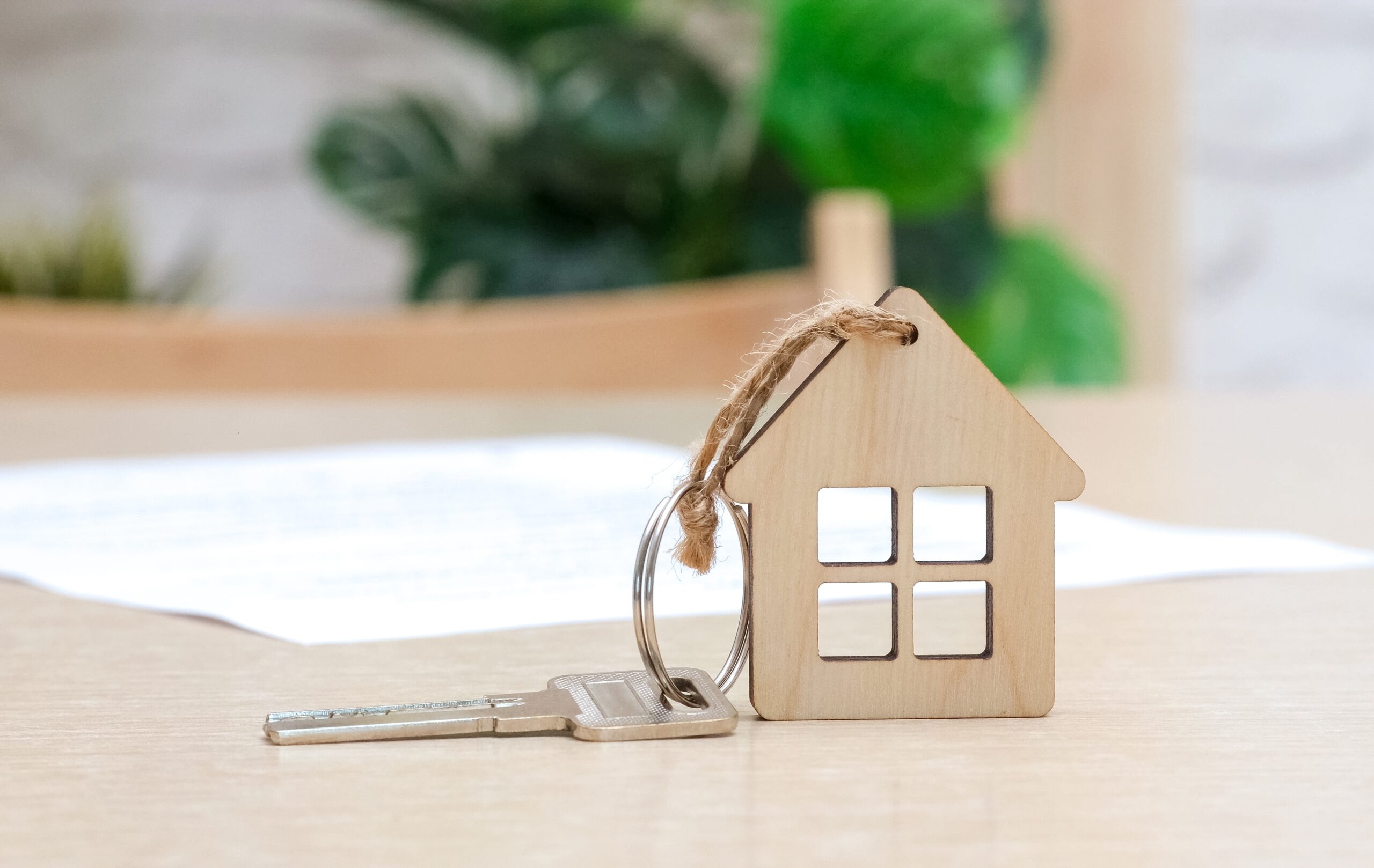 small wooden house with a key attached to it