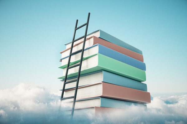 ladder that is leaning on stacked books