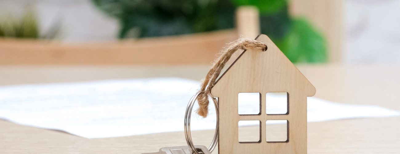 small wooden house with a key attached to it